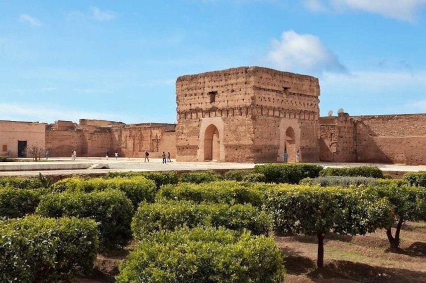 A historical building with arched gateways, surrounded by well-maintained greenery. 2