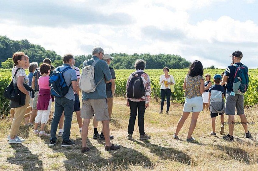 A group of people standing in a field with a hilly landscape in the background. 4