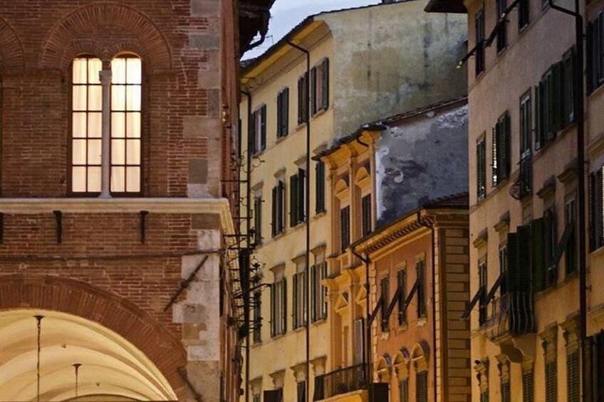 A historic building with arched windows and a brick facade. 5