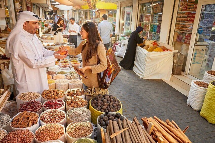 A market with various food items on display, including nuts, spices, and dried fruits. 4