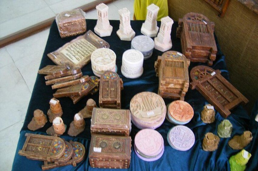 A collection of intricately carved wooden boxes and containers on a blue cloth. 2