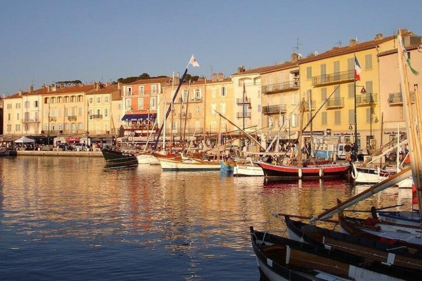 A harbor with boats, buildings, and a clear sky. 1