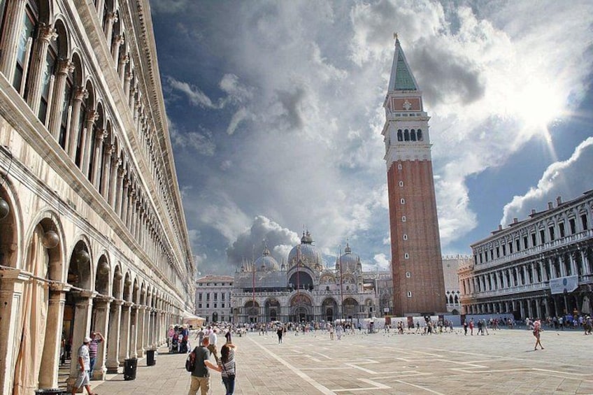 A historic square with a prominent tower, a large dome, and classical architecture. 3