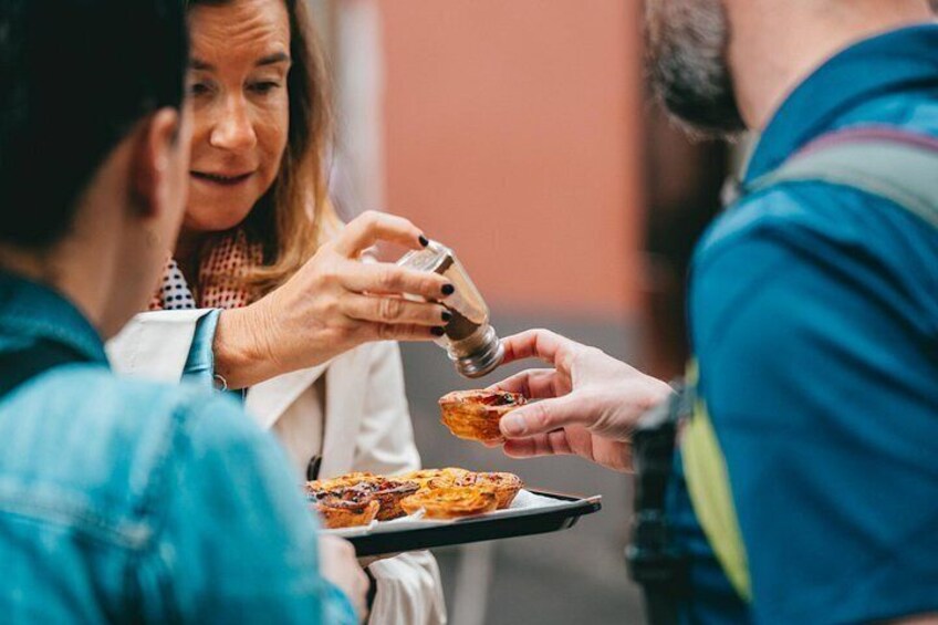 A person holding a tray with pastries. 4