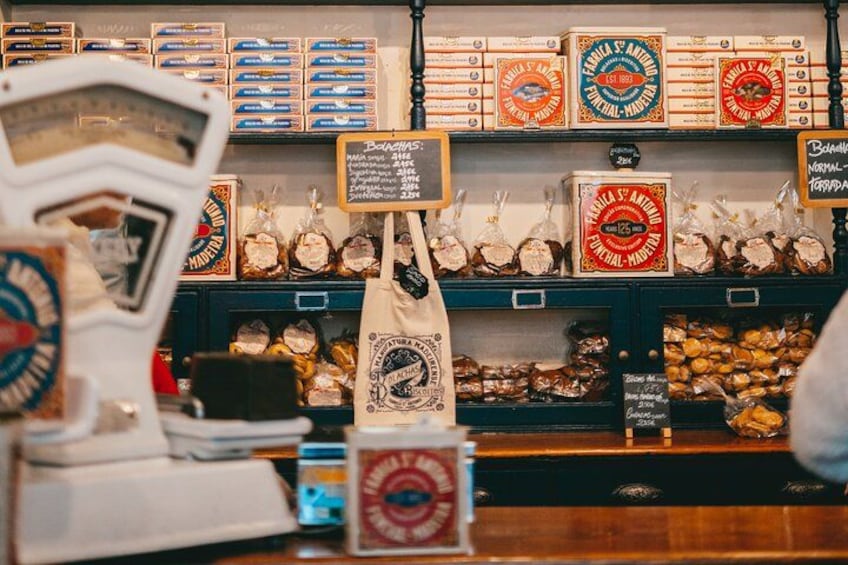 A bakery display with various baked goods and a cash register. 4