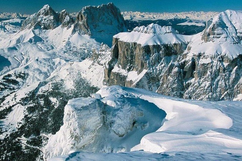 A snow-covered mountain range with sharp peaks and rugged terrain. 1