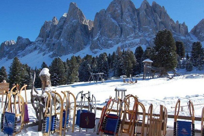 A snowy mountain landscape with ski equipment and a wooden structure. 2