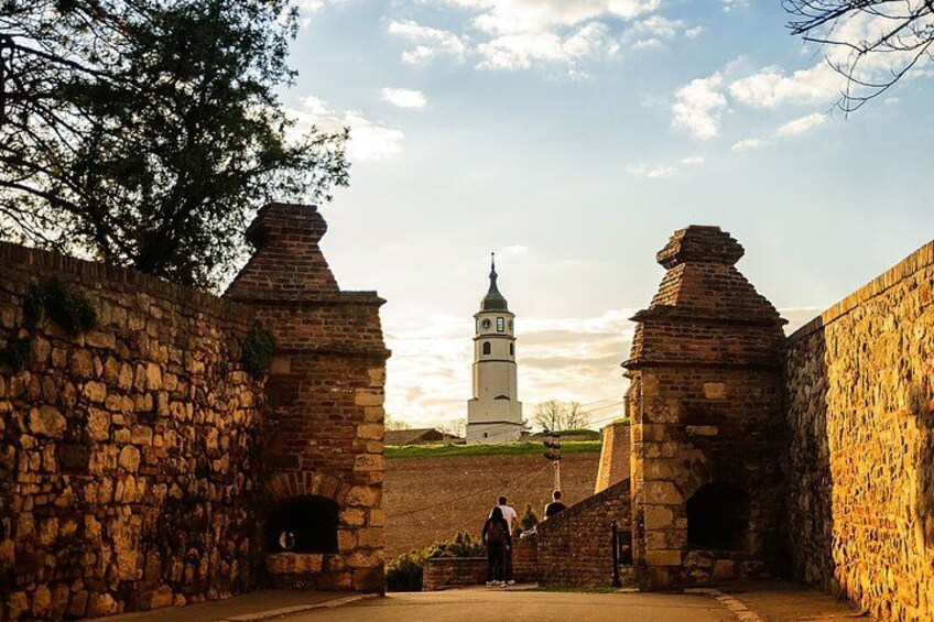 A stone wall with a bell tower in the background. 1
