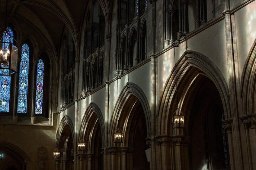 A cathedral interior with stained glass windows and arched ceilings. 3