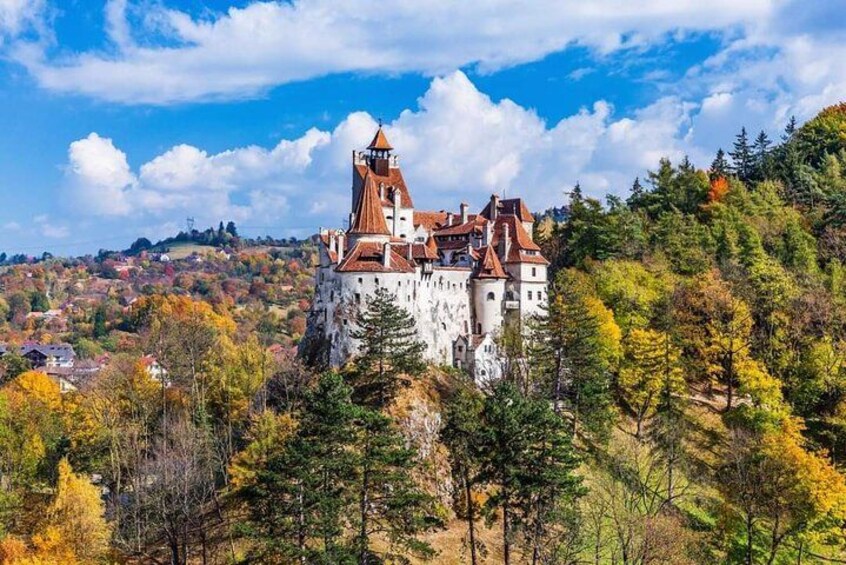 A castle on a hill with autumn foliage. 1