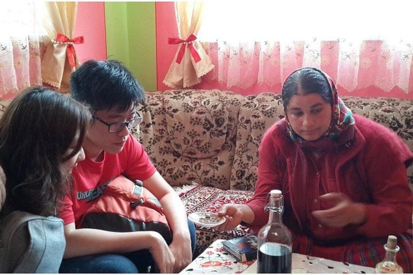 A family sitting on a sofa with a table in front of them. 4