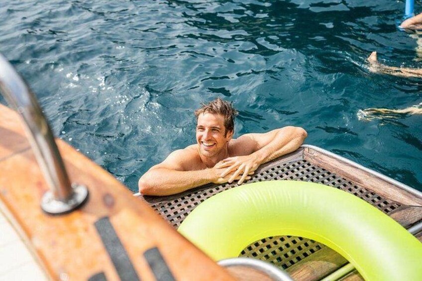 A person in a boat with a green inflatable ring. 4