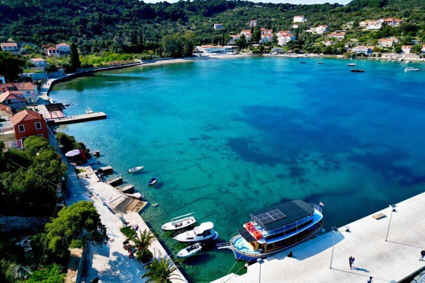A coastal town with a marina, boats, and houses along the shore. 3