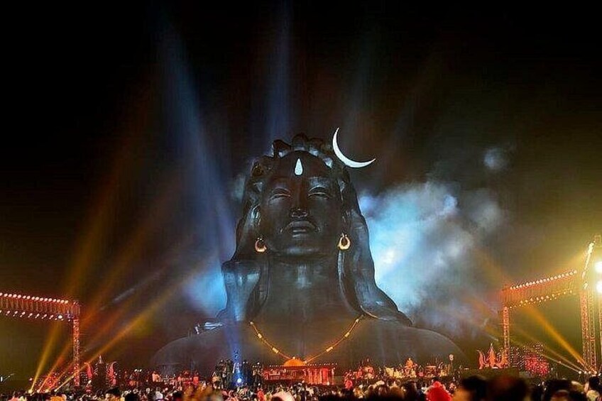 A large statue illuminated by spotlights at night. 3