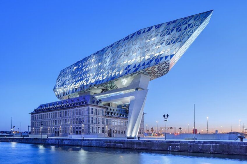 A modern architectural building with a unique, angular design, situated by a waterfront. 5