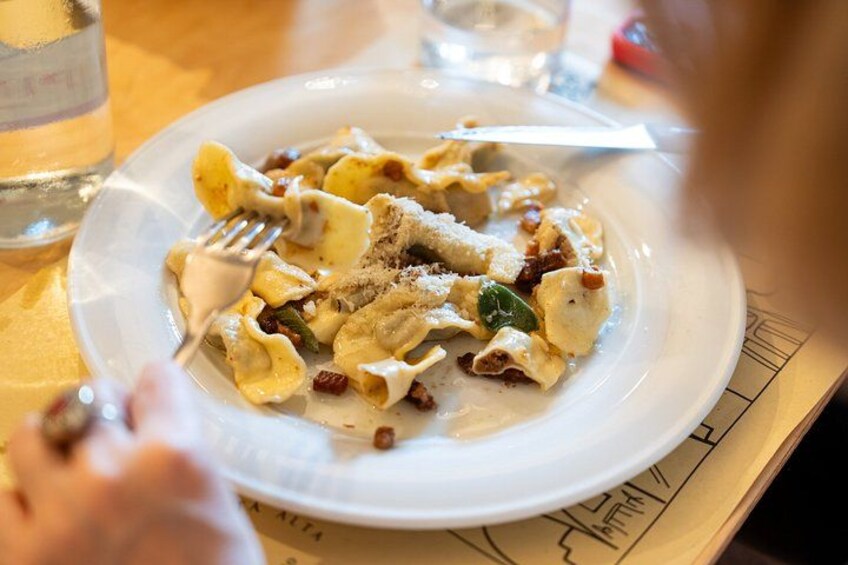 A plate of pasta with a fork on it. 3
