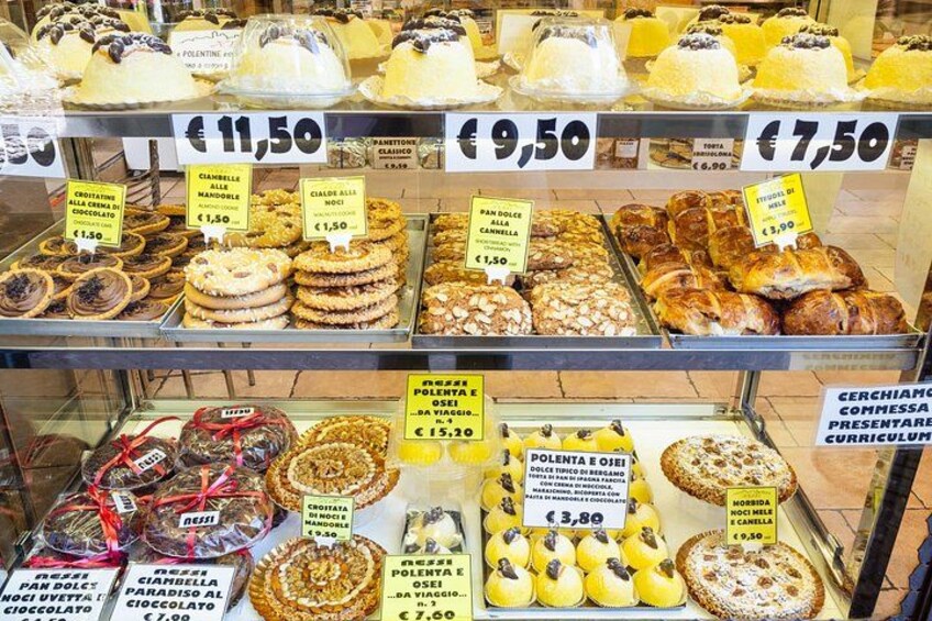 A bakery display with various pastries and desserts. 2