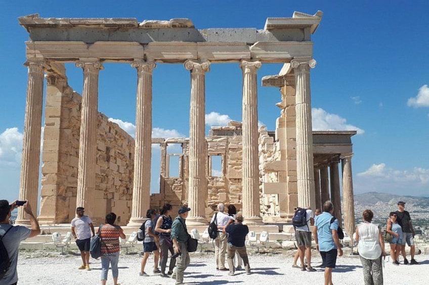 Ancient Greek ruins with columns and visitors. 1