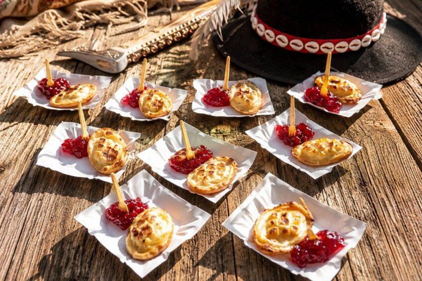 Pastries on toothpicks with jam, arranged on a wooden surface. 4