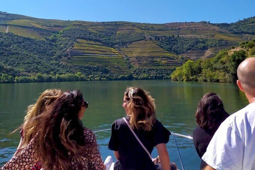 People on a boat on a lake with hilly landscape in the background. 5