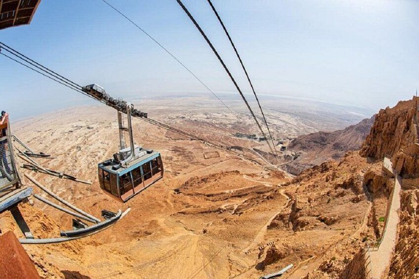 A cable car system in a desert landscape with a clear sky. 4