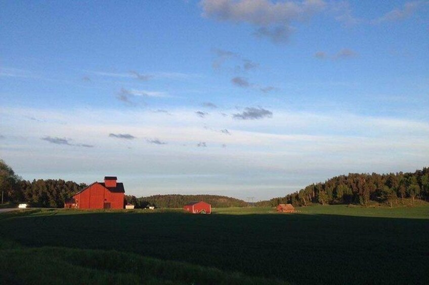 A red barn, open fields, and a forest in the background. 4