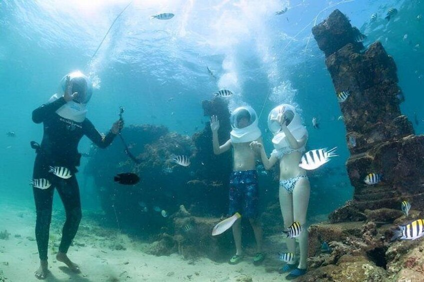 An underwater scene with divers and fish. 5