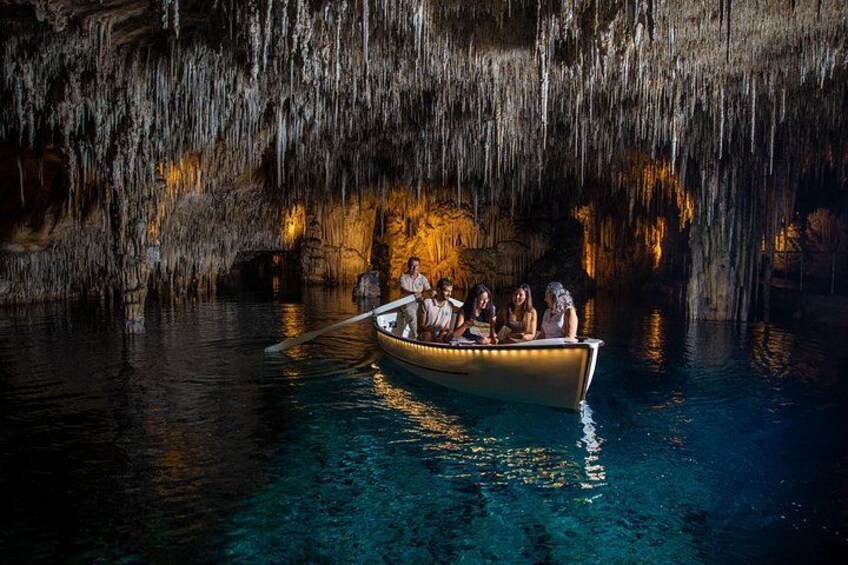 A boat with people on a river surrounded by cave walls. 3