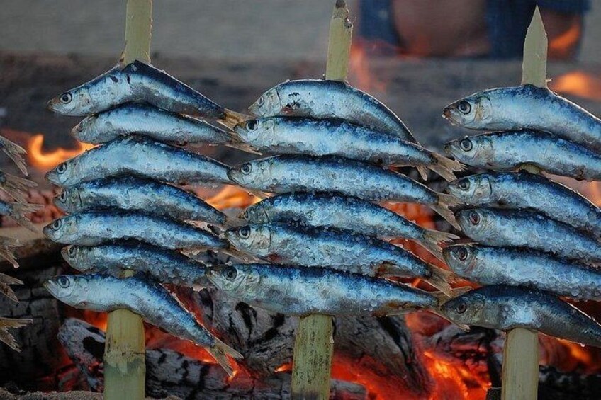 Grilled fish on skewers over an open flame. 3