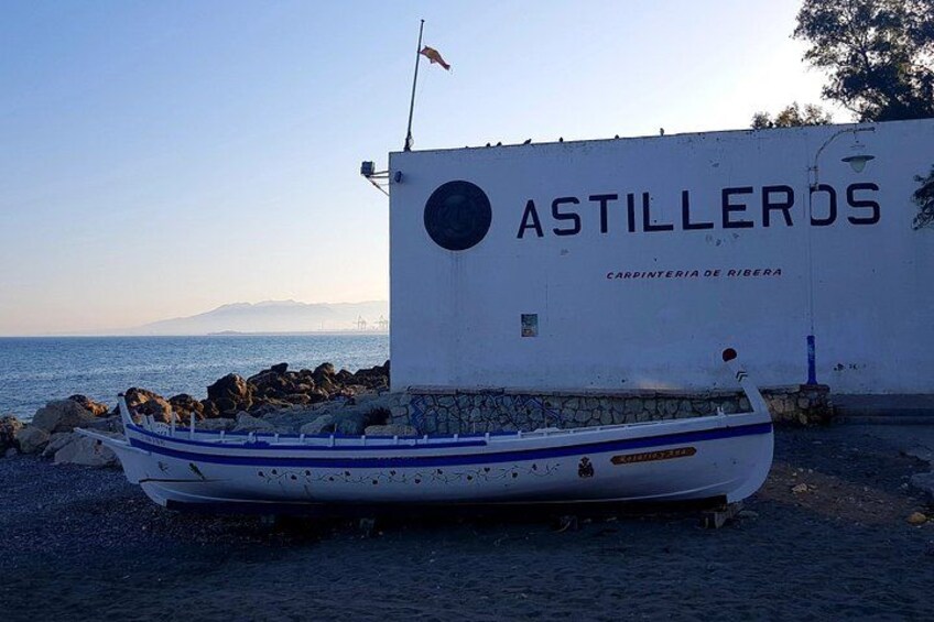 A boat docked near a building with 'ASTILLEROS' written on it. 4