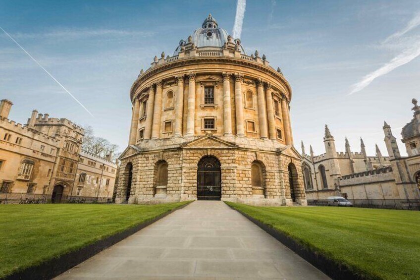 A historic building with a central dome, surrounded by well-manicured lawns and classical architecture. 1