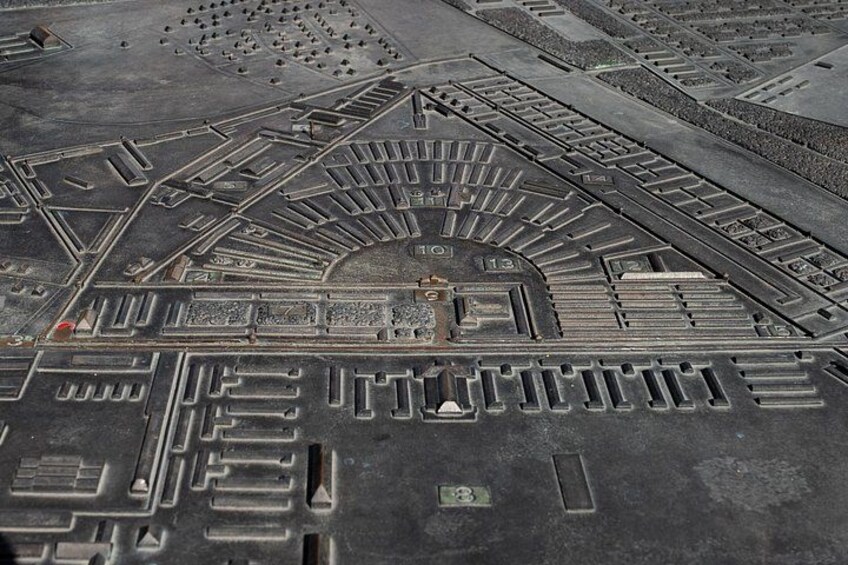 An aerial view of a stadium with a central field surrounded by seating sections. 2