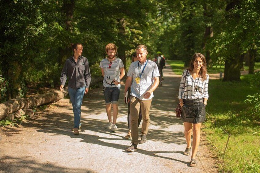 A group of people walking on a dirt path surrounded by trees. 3