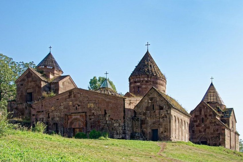 A historic church with multiple domes and crosses, surrounded by a grassy area. 3
