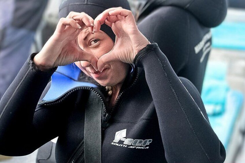 A person wearing a wetsuit with a logo and text on it. 3