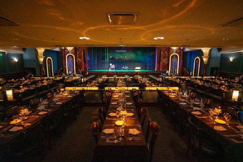 A banquet hall with long tables set for a formal event. 2