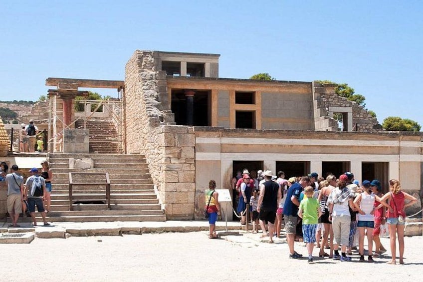 Ancient ruins with tourists gathered around. 4