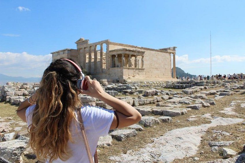 A person taking a photo of the Parthenon in Athens. 1