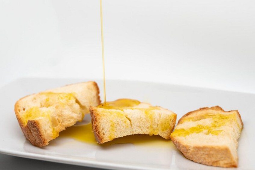 Three slices of toast with melted butter on a white plate. 2