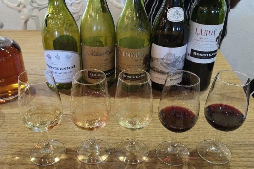 Wine bottles and glasses on a wooden table. 3