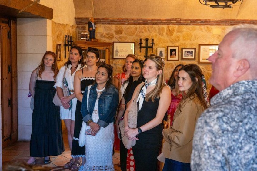 A group of people standing indoors, possibly at a social gathering or event. 2