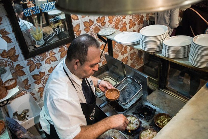 Preparing shrimp tapas during a food and wine tasting tour of Madrid. 2