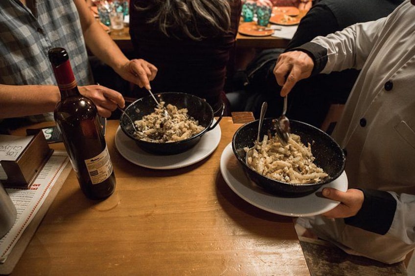 Chef demonstrates the art of making tapas on a food tasting tour. 5