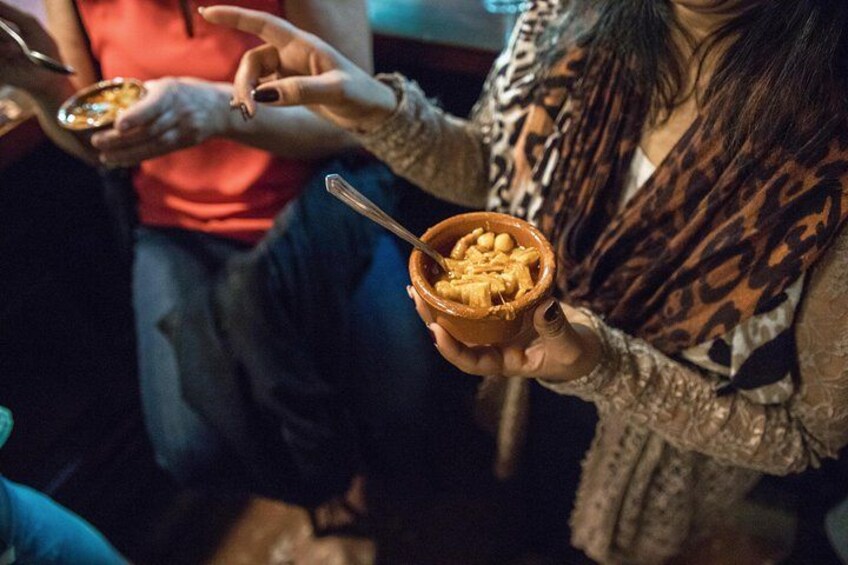 Diners bite into bowls of “callos a la Madrilena,” or Madrid-style tripe. 4