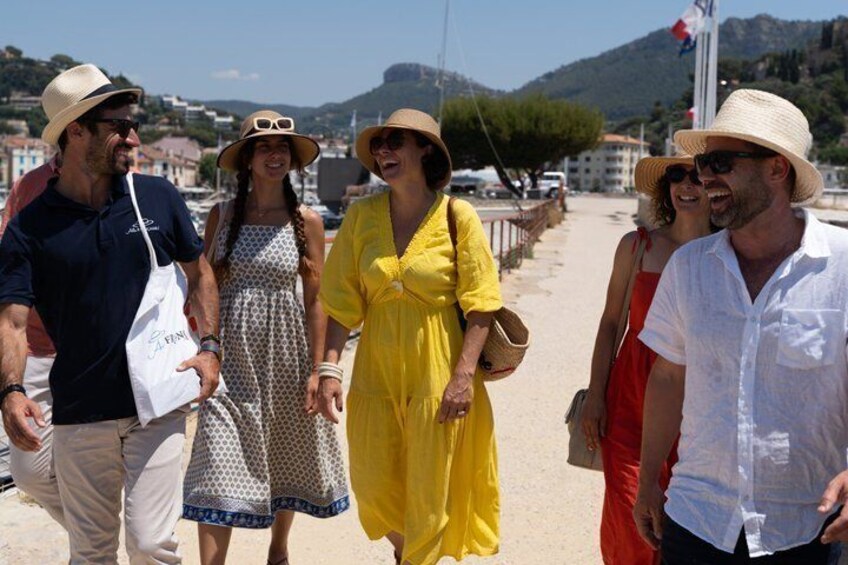 A group of people walking on a beach with a mountainous backdrop. 5
