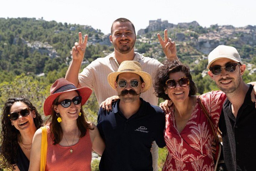 A group of people posing with a mountainous landscape in the background. 4