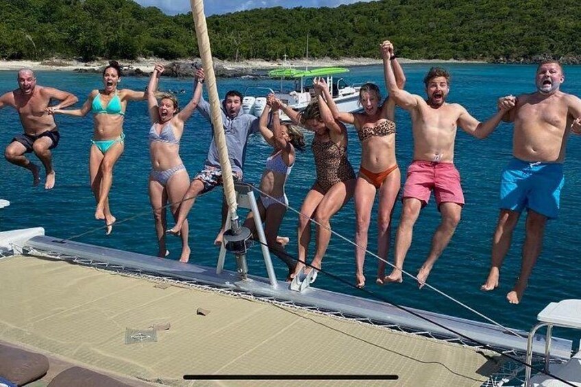 A group of people jumping off a boat into the water. 2