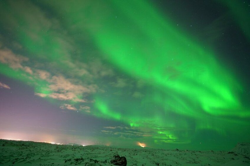 A snowy landscape with the Northern Lights. 4