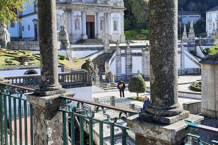 A historic building with classical architecture, a well-maintained garden, and a stone staircase leading to the entrance. 3