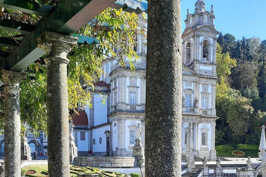 A historic building with classical architecture, surrounded by trees and a clear sky. 2
